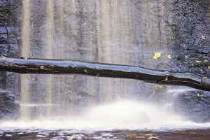 Uninhabited River Scenery Prints: Waterfall on a rock face with a tree log