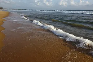 Evening Sun Sky Prints: Wave surging on sand on beach