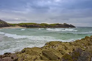 Cloudy Coastal Scene Prints: Waves meet rugged rocks on a dramatic coast