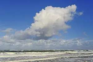 Cumulus Clouds Germany Prints: Waves running out at the sandy beach