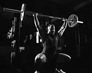 Caucasian Male Athlete Prints: Weightlifter does an exercise with a barbell