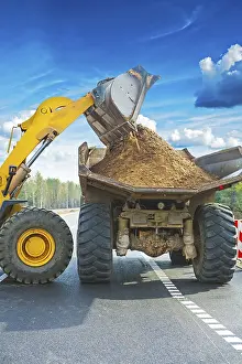Construction Site Prints: Wheel loadder loadding ground on tipper