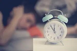 White Alarm Clock Prints: White alarm clock on the bedside table