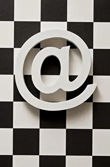 Chess Board Design Prints: White e-mail symbol @ on a black and white checkerboard pattern background