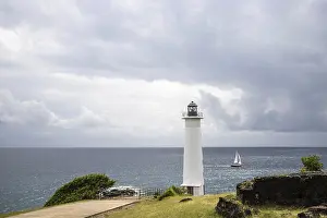 Prints of White lighthouse on a steep coast. Dramatic clouds with a view of the sea, pure Caribbean at Le Phare du Vieux-Fort, on Guadeloupe, French Antilles, France Guadeloupe Prints: White Lighthouse Print: Guadeloupe Coastline Scene