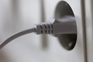 Symbolic Energy Image Prints: White power plug in a socket on the wall