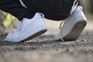 Gravel Path Germany Prints: White trainers of an athletically dressed boy