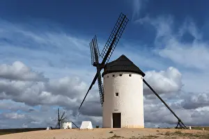 Don Quixote Route Photography Prints: White windmill under a dramatic sky with other mills in the background