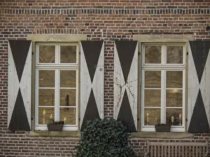 European Architecture Style Prints: Two whitewashed windows with shutters on a brick wall