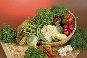 Wicker Basket Prints: Wicker basket and vegetables on a studio background