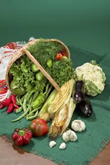 Wicker Basket Prints: Wicker basket and vegetables on a studio background