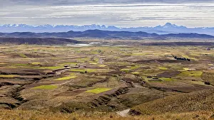 Mountain Chain Landscapes Prints: Wide landscape with fields and distant mountains