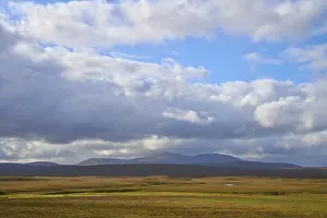 Scottish Mountain Photography Prints: Wide plain with mountain views and dramatic sky with thick clouds