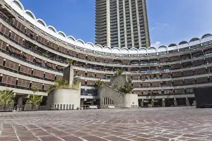 Prints of Wide view of the Barbican Estate in London with curved terraces, courtyard and tower under blue sky. Classic brutalist and modernist architecture Brutalist Architecture Prints: Wide View of the Barbican Estate in London Print
