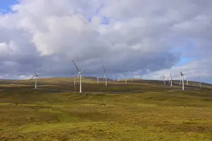 Alternative Energy Landscape Prints: Wind turbines scattered across fields under a cloudy sky