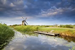 Blue Sky Reflection Prints: Windmill on riverside with reflected blue sky