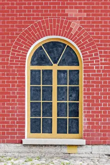 Glazed Tile Designs Prints: Window with arch and bars in the background of wall of red brick