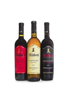 Wine Bottles Prints: Three wine bottles are lined up next to each other