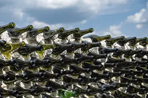 Close Up Wine Bottle Prints: Wine bottles in a row on a stone wall