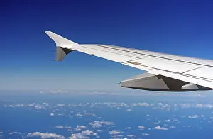 Deserted City Skyline Prints: Wing of an airplane, view from window