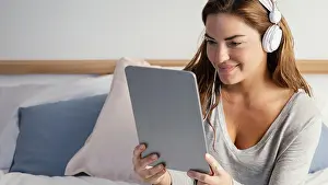 Leisure Activities Prints: Woman with headphone using tablet