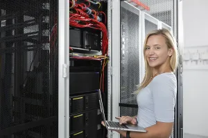 Server Room Technician Prints: Woman with laptop programing in server room