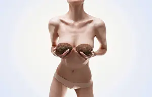 Studio Beauty Shot Prints: Woman posing in the studio with coconuts in her hands
