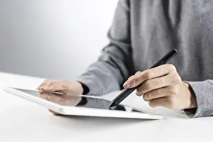 Business Attire And Technology Prints: Woman using tablet computer for project management
