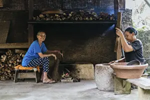 Rustic Kitchen Prints: Two women work in a rustic kitchen