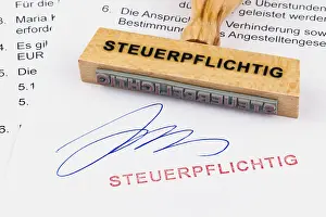 Office Supply Prints: A wooden stamp is placed on a document