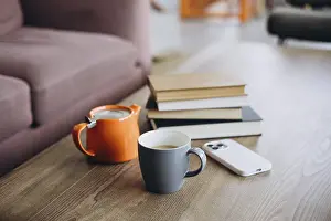 Minimalist Home Decor Prints: A wooden table with a stack of books