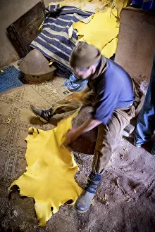 African Handicrafts Prints: Worker working on leather, dying