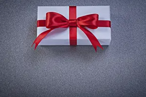 Birthday Present Idea Prints: Wrapped present box on grey surface holidays concept