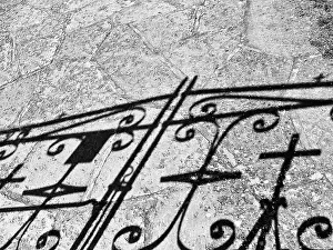 Black And White Travel Photography Prints: Wrought iron gate with cross casting shadows on a path