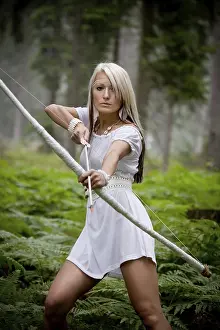 Primeval Forest Scenery Photo Prints: A young amazon with a bow in the rainforest