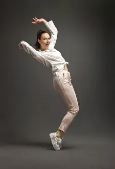 Young Dancer Prints: Young and beautiful dancer posing in studio at grey background
