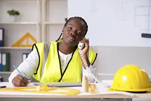 One Person Laboring Prints: Young black architect working on project