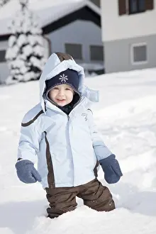 Winter Clothing For Kids Prints: Young boy standing in the deep snow