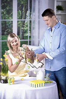 Christian Holiday Traditions Prints: Young couple decorating for Easter