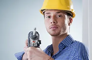 Craftsman At Work Prints: Young craftsman using a drill