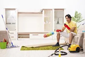 Man Doing Household Chores Prints: Young handsome man doing housework