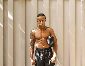 Kickboxer Portrait Prints: Young kickboxer standing at a wall after training looking at the camera