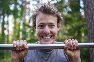 Athletic Male Portrait Prints: Young man doing pull-ups on a pull-up bar
