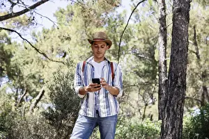 Smartphone User Prints: A young man, dressed casually with a hat