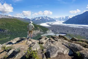 Chugach Mountains Scenery Prints: Young man enjoying the view, view of impressive mountain landscape with Matanuska glacier and glaciated mountain peaks