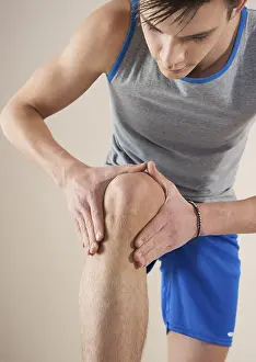 Prints of Young man examining his knee, Mannheim, Baden-Wurttemberg, Germany Young man examining his knee, Mannheim, Baden-Wrttemberg, Germany Mannheim Prints: Young Man Examining His Knee Print, Mannheim, Germany