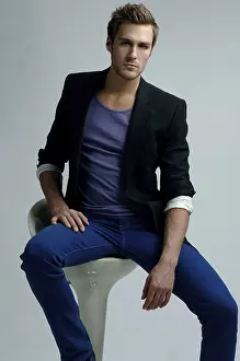Young Man Fashion Prints: Young man in a jacket sitting on a stool
