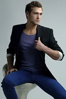 Young Man Fashion Prints: Young man in a jacket sitting on a stool