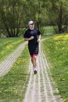 Fitness Man Prints: A young man jogging through the fields
