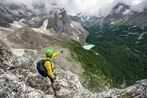 Via Ferrata Prints: Young man points into the distance